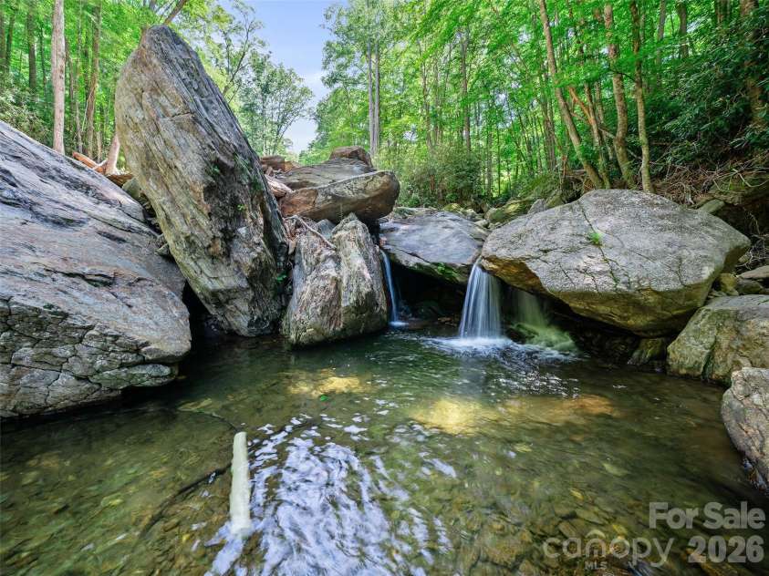 552 Fork Road, Burnsville, NC 28714.  MLS# CAR4395564, YatesRealty ID 32097. 8 foot waterfall and swimming hole 