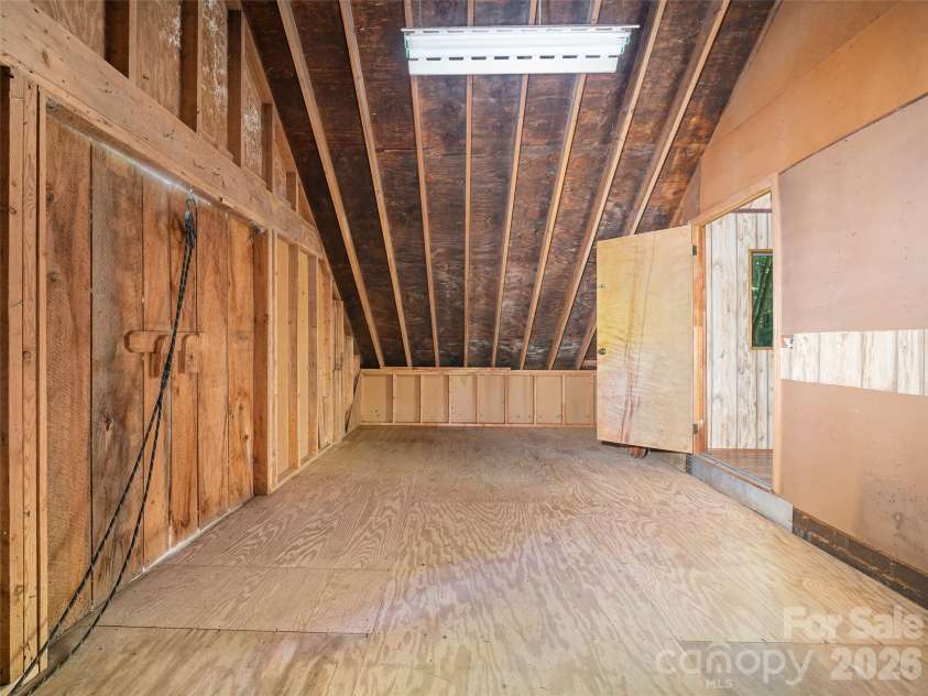 552 Fork Road, Burnsville, NC 28714.  MLS# CAR4395564, YatesRealty ID 32097. Extra Upper level storage above the garage  with farmhouse doors 