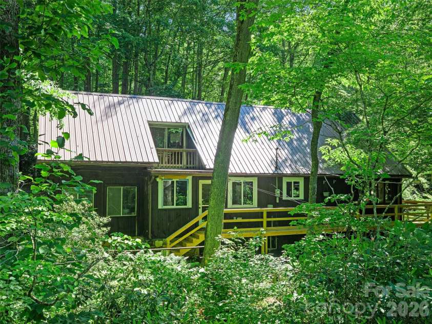 552 Fork Road, Burnsville, NC 28714.  MLS# CAR4395564, YatesRealty ID 32097. WEst facing side of home  with wrap around new decking 