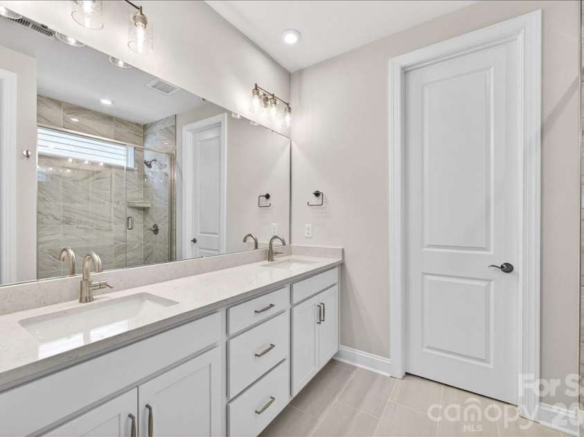 12015 Elsa Lane, Charlotte, NC 28277.  MLS# CAR4396074, YatesRealty ID 32126. Dual vanity primary bathroom