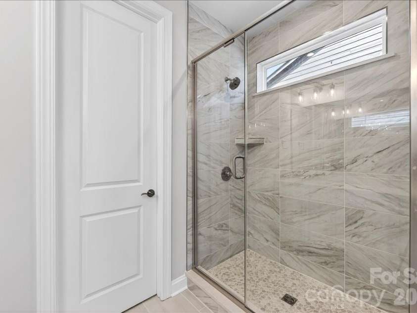 12015 Elsa Lane, Charlotte, NC 28277.  MLS# CAR4396074, YatesRealty ID 32126. Tiled primary walk-in shower