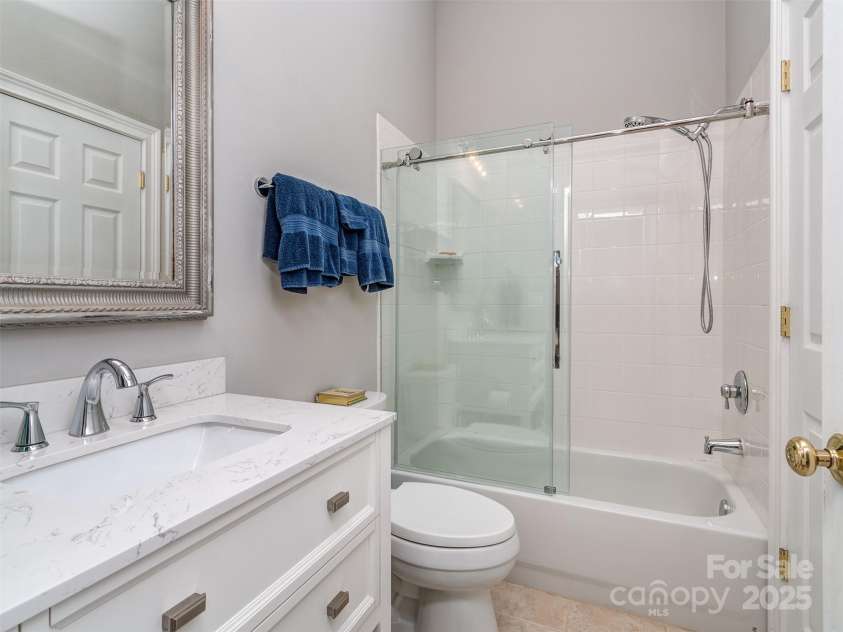 17709 Sedona Way, Cornelius, NC 28031.  MLS# CAR4274595, YatesRealty ID 32132. Large Guest Bath with Oversized Vanity Sink, Quartzite Countertop, Tile Flooring, & Custom Wall Mirror.