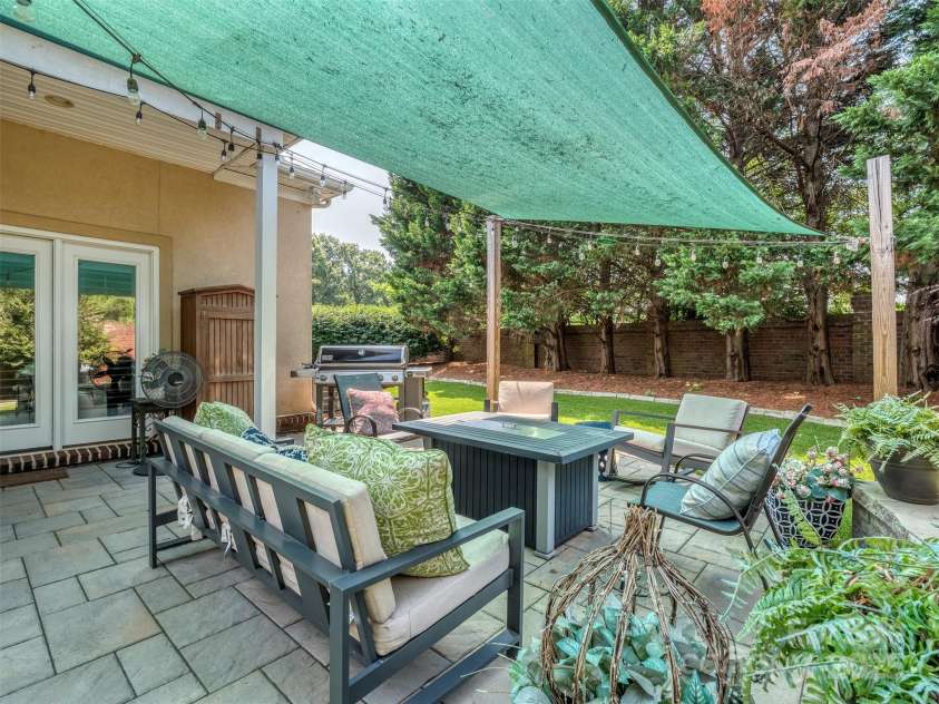 17709 Sedona Way, Cornelius, NC 28031.  MLS# CAR4274595, YatesRealty ID 32132. Permeable Paver Patio (never standing water) with Screen Cover, Wired Hanging Lights, & Pet Friendly No Maintenance Turf in the Fully Fenced Rear Yard!