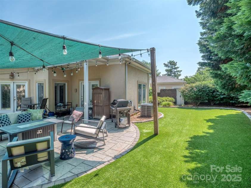 17709 Sedona Way, Cornelius, NC 28031.  MLS# CAR4274595, YatesRealty ID 32132. Permeable Paver Patio (never standing water) with Screen Cover, Wired Hanging Lights, & Pet Friendly No Maintenance Turf in the Fully Fenced Rear Yard!