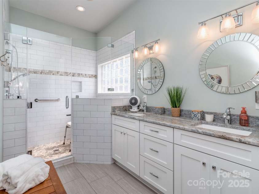 17709 Sedona Way, Cornelius, NC 28031.  MLS# CAR4274595, YatesRealty ID 32132. The Oversized Primary Bath has Custom Walk-In Shower, Granite Countertops, Dual Vanity, Oversized Tile Flooring, Recessed & Sconce Lighting