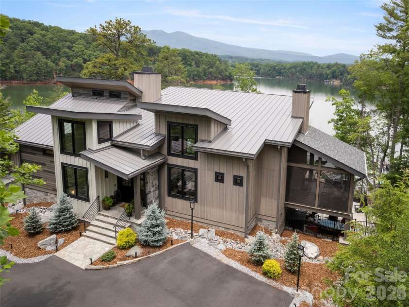 425 Dockside Drive, Nebo, NC 28761.  MLS# CAR4393009, YatesRealty ID 32158. Front elevation with lake and mountains in the background.