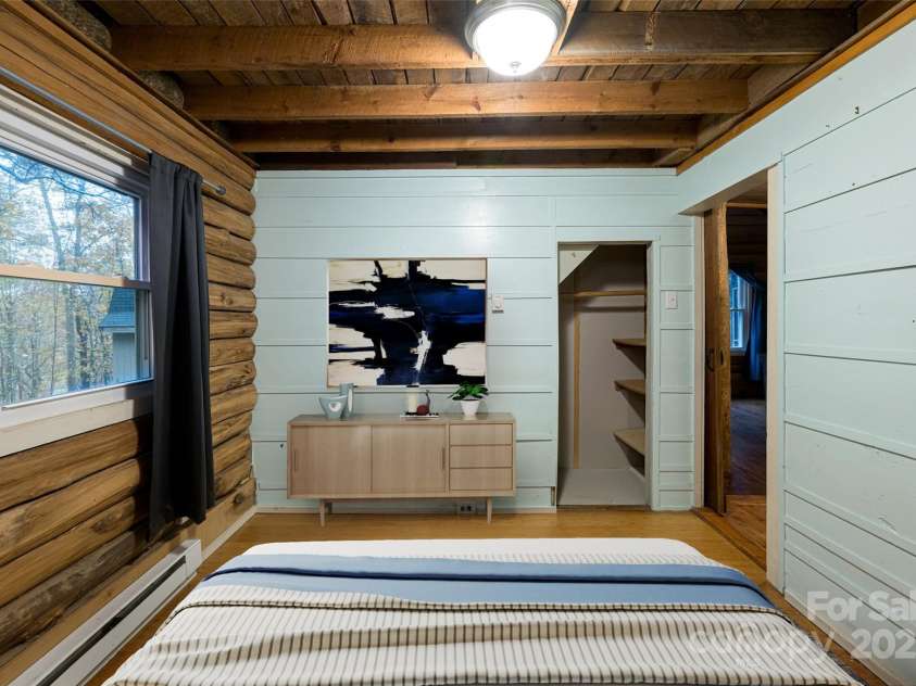 49 & 51 Mayapple Lane, Brevard, NC 28712.  MLS# CAR4288314, YatesRealty ID 32158. Virtually staged main level primary bedroom