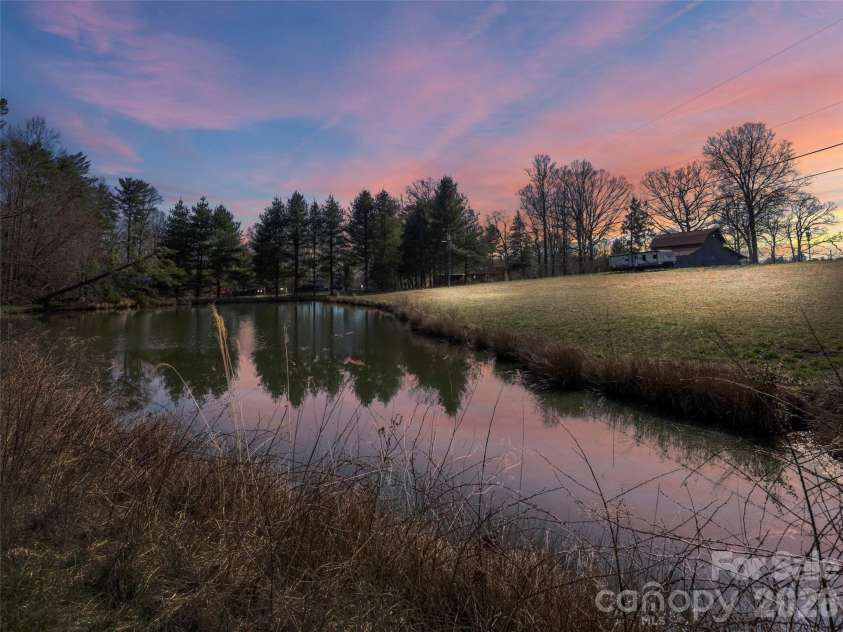 54 Old Lime Kiln Road, Arden, NC 28704.  MLS# CAR4394473, YatesRealty ID 32159. Beautiful sunset reflecting off the pond.