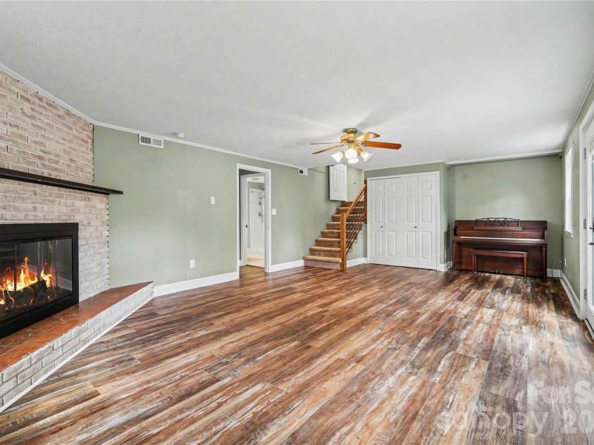 3035 River Road, Shelby, NC 28152.  MLS# CAR4393032, YatesRealty ID 32187. The stairs to the lower level include a custom railing. There is currently a piano in this den that will remain!