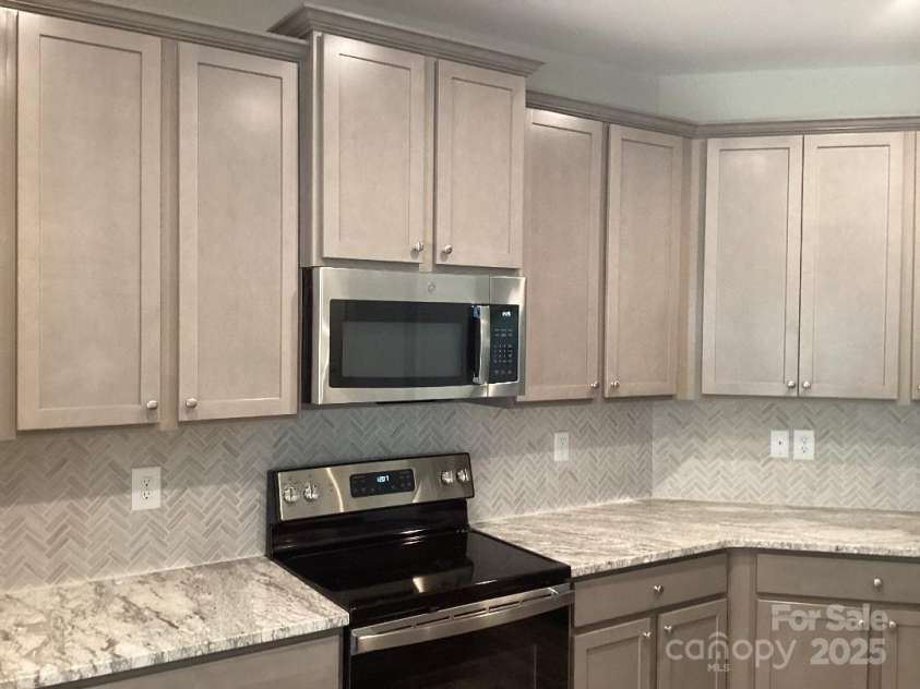 5126 Rocky River Crossing Road, Harrisburg, NC 28075.  MLS# CAR4277877, YatesRealty ID 32189. Kitchen Upgrades include: Countertops, Back Slash and Cabinets.