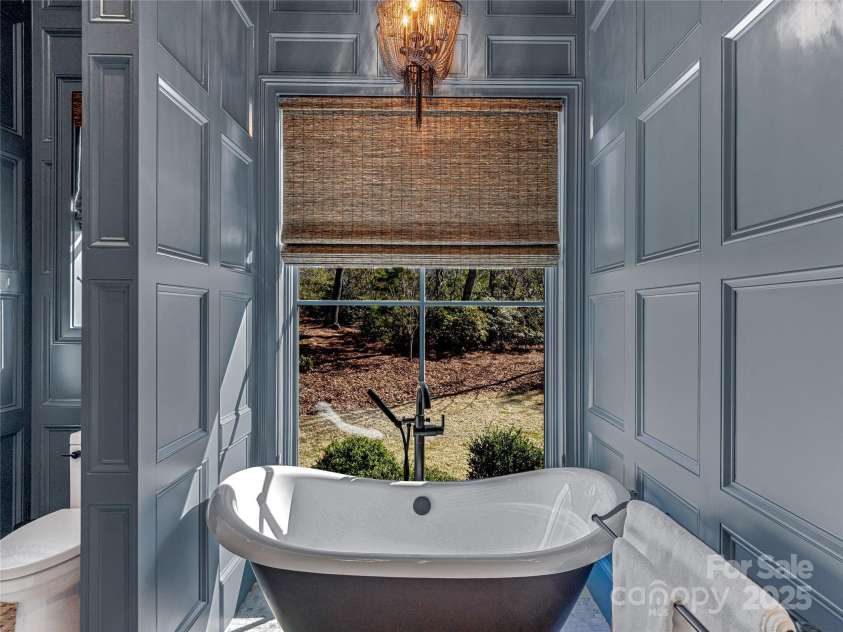 1905 White Tree Trail, Arden, NC 28704.  MLS# CAR4230669, YatesRealty ID 3219. Private soaking slipper tub in main level guest bathroom ensuite.