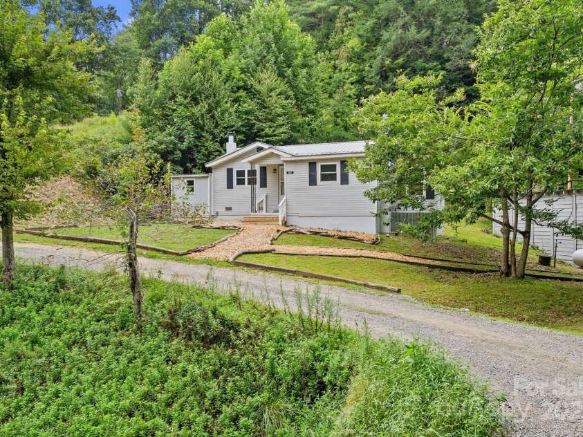 530 Rebel Ridge Road, Marshall, NC 28753.  MLS# CAR4280737, YatesRealty ID 32197. The acreage does extend across Rebel Ridge and down to the Laurel River