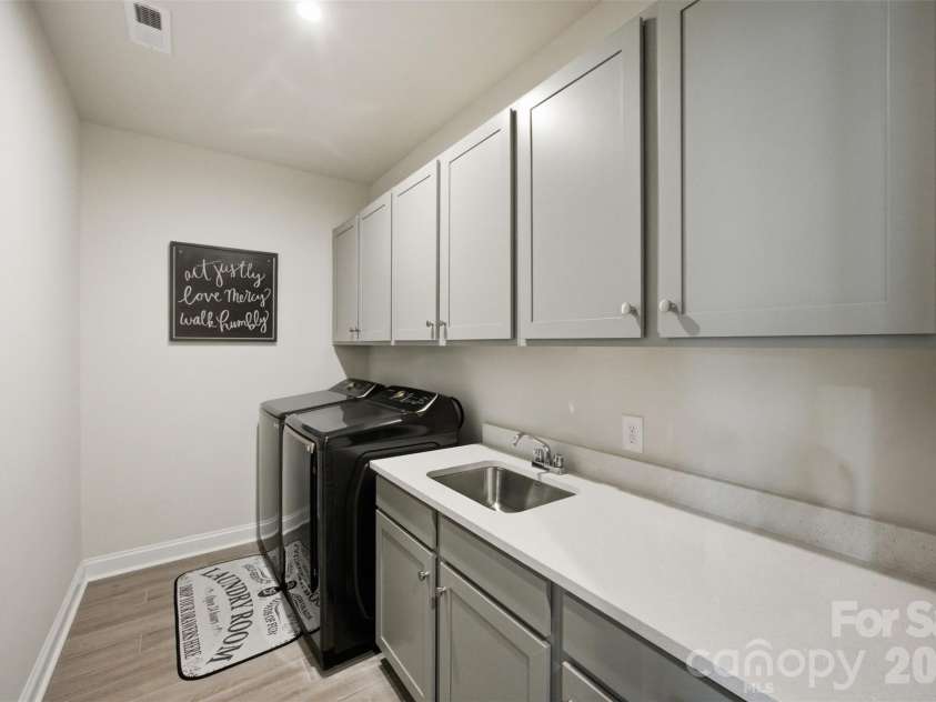 510 Meadow Ridge Drive, Belmont, NC 28012.  MLS# CAR4412652, YatesRealty ID 32204. Upper level laundry room- complete with built in cabinetry.