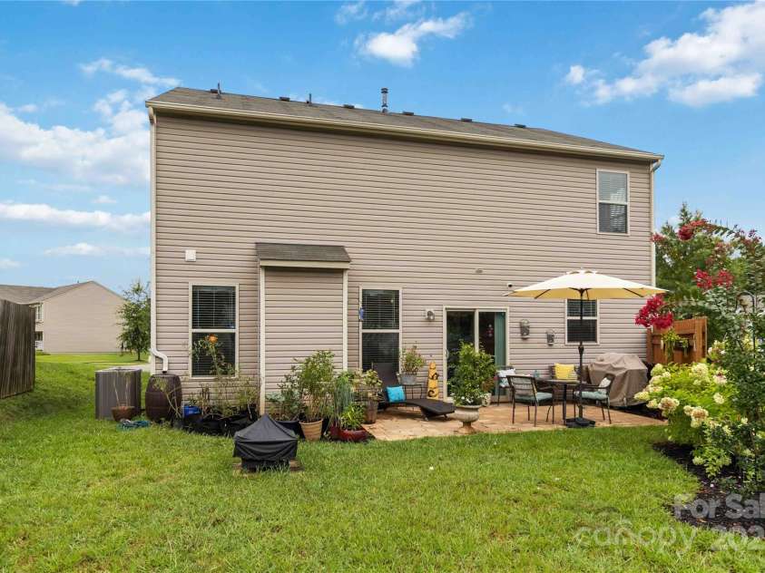 4626 Gibbons Link Road, Charlotte, NC 28269.  MLS# CAR4290378, YatesRealty ID 32205. Private backyard with stone patio—ideal for outdoor living.