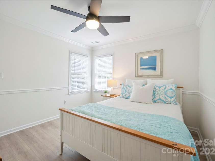 21203 Harken Drive, Cornelius, NC 28031.  MLS# CAR4253186, YatesRealty ID 32227. Spacious Secondary Bedroom on upper level with crown molding & ceiling fan/light!