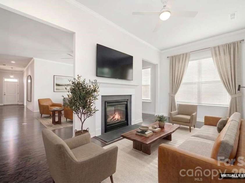 456 Lucky Drive, Concord, NC 28027.  MLS# CAR4313263, YatesRealty ID 32227. Virtually staged sunroom and two-sided fireplace.