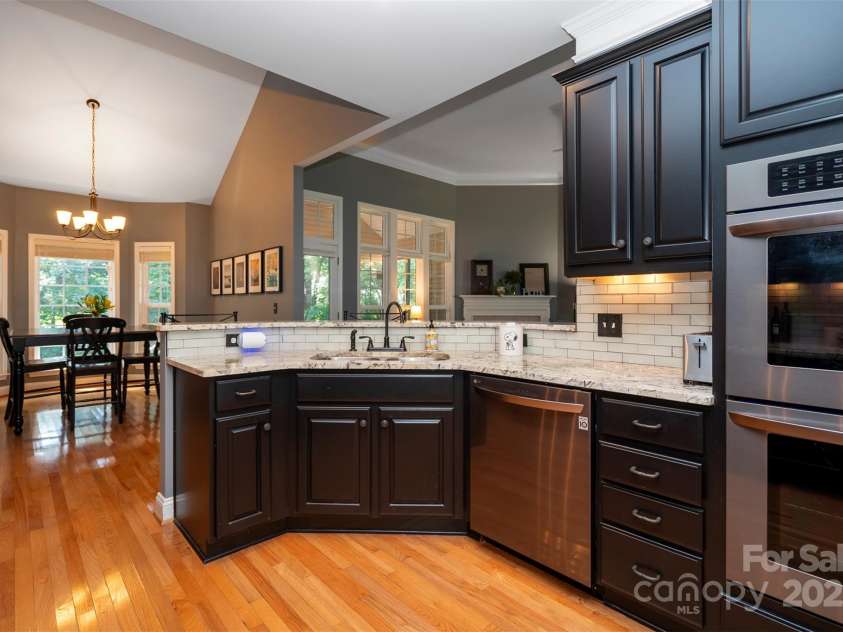 126 Doyle Farm Lane, Mooresville, NC 28115.  MLS# CAR4270254, YatesRealty ID 32228. Updated Kitchen featuring gorgeous     natural granite counters, dual oven, smooth top electric cooktop, 42” under lit cabinets and breakfast bar.