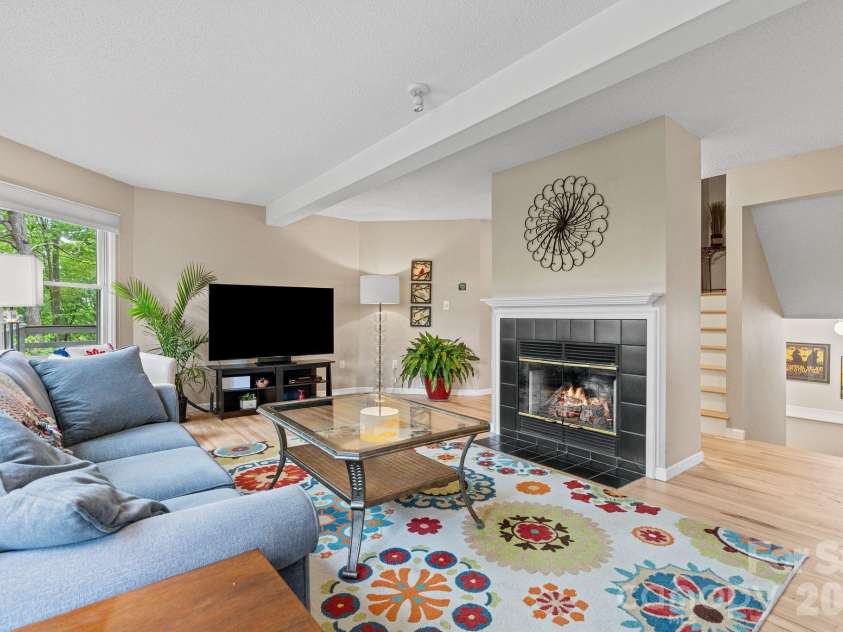 58 Sourwood Drive, Mills River, NC 28759.  MLS# CAR4390836, YatesRealty ID 32251. Living room with natural gas fireplace