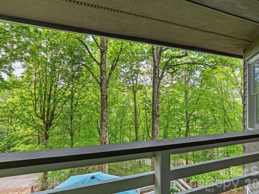 58 Sourwood Drive, Mills River, NC 28759.  MLS# CAR4390836, YatesRealty ID 32251. Primary bedroom covered porch