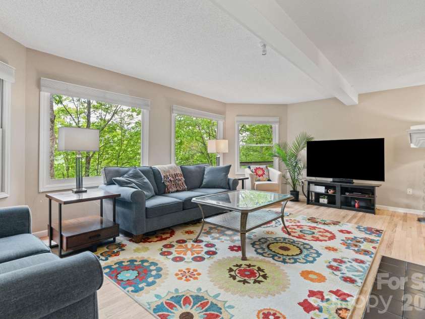 58 Sourwood Drive, Mills River, NC 28759.  MLS# CAR4390836, YatesRealty ID 32251. Sunny living room with huge windows