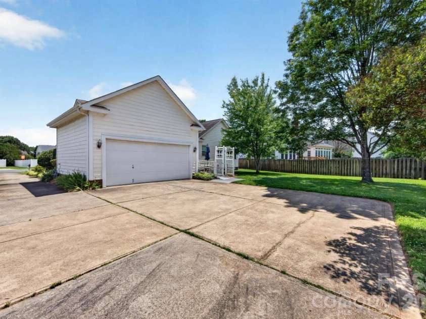 7716 Conifer Circle, Indian Trail, NC 28079.  MLS# CAR4389738, YatesRealty ID 32257. The driveway here is longer than average and has a double wide parking pad for the rear load 2 car garage which allows for extra parking for family or guests