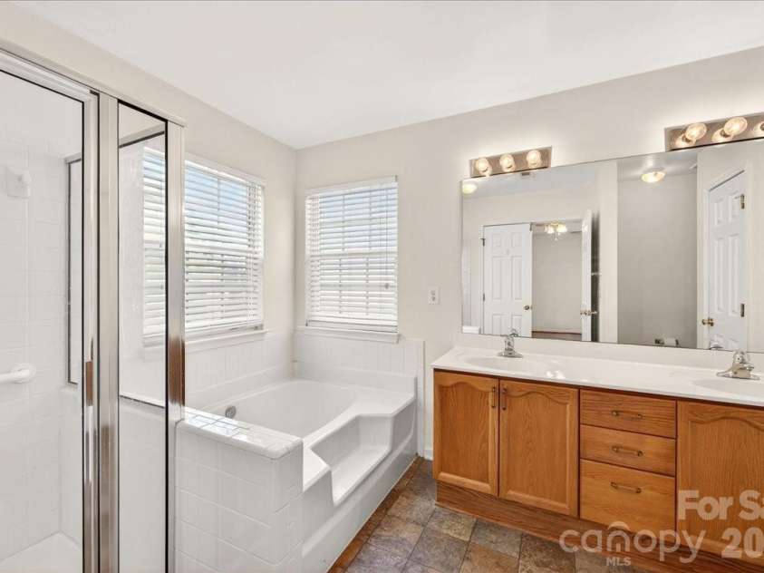 7716 Conifer Circle, Indian Trail, NC 28079.  MLS# CAR4389738, YatesRealty ID 32257. The primary bath has a double sink vanity and includes a shower AND a soaking tub so a plus with those who have a oreference. There is alos a separate 