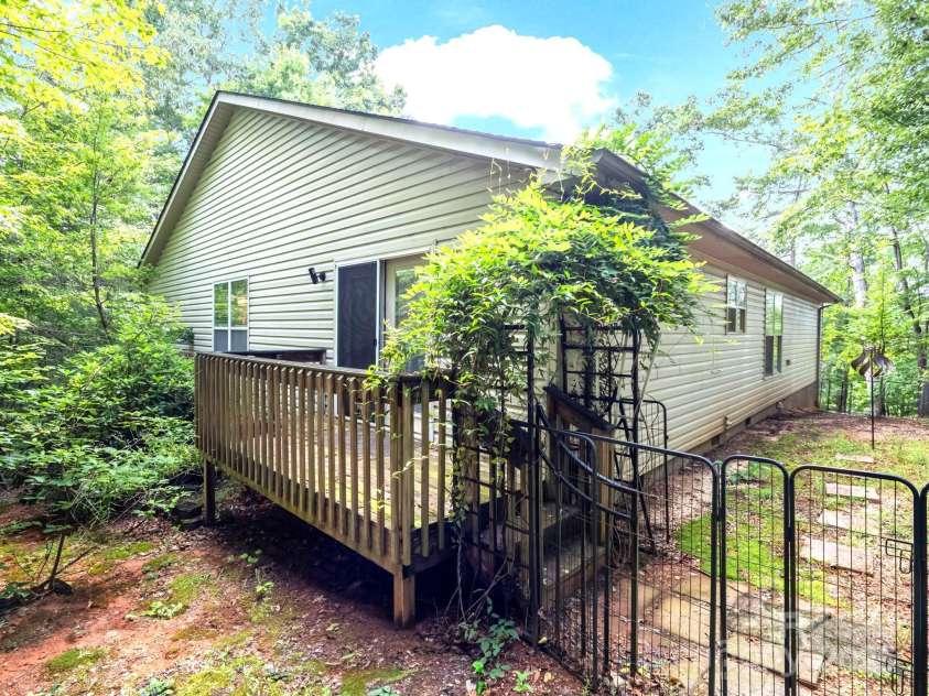 134 Downing Place, Lake Lure, NC 28746.  MLS# CAR4289968, YatesRealty ID 32258. Back Deck off Dining area. Side yard