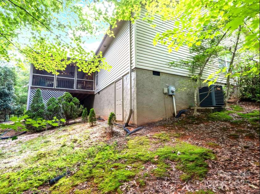 134 Downing Place, Lake Lure, NC 28746.  MLS# CAR4289968, YatesRealty ID 32258. Back yard & walk-in crawl space/storage