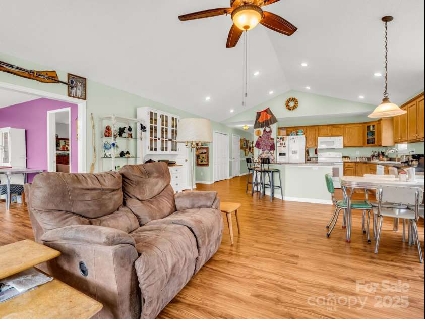 27 Gray Wolf Lane, Hendersonville, NC 28792.  MLS# CAR4285060, YatesRealty ID 32261. Living Room Opens to Finished Sunroom