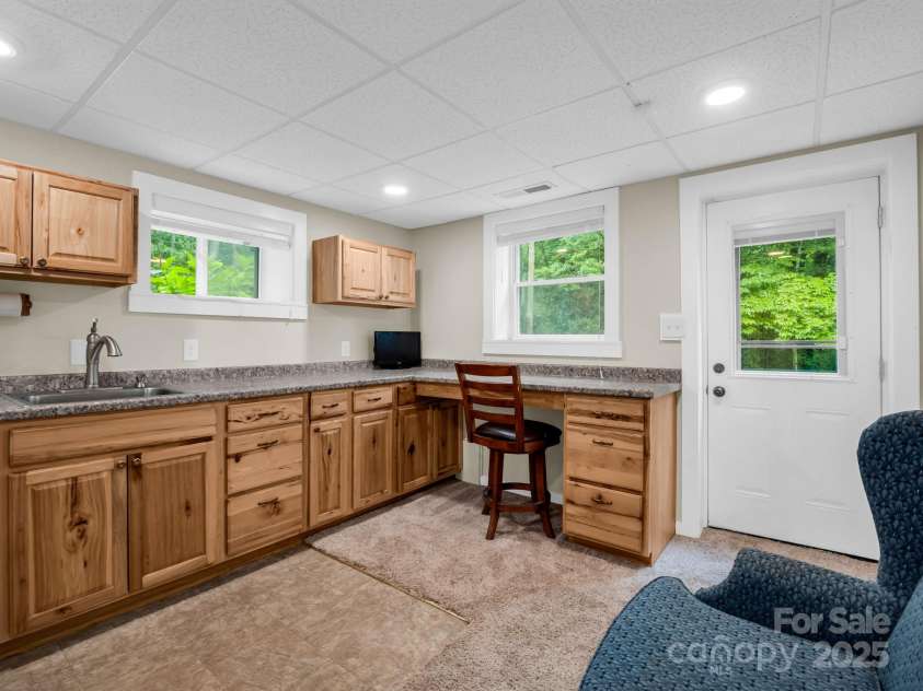 612 Buckeye Cove Road, Swannanoa, NC 28778.  MLS# CAR4287108, YatesRealty ID 32265. Basement level kitchenette with refrigerator.