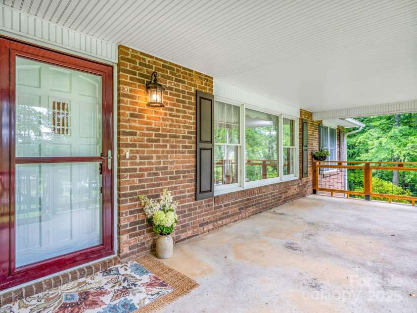 612 Buckeye Cove Road, Swannanoa, NC 28778.  MLS# CAR4287108, YatesRealty ID 32265. Fully covered front porch offers plenty of space for outdoor furniture.