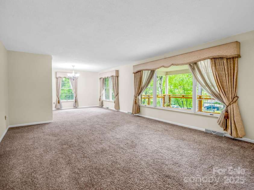 612 Buckeye Cove Road, Swannanoa, NC 28778.  MLS# CAR4287108, YatesRealty ID 32265. Living room and dining area.