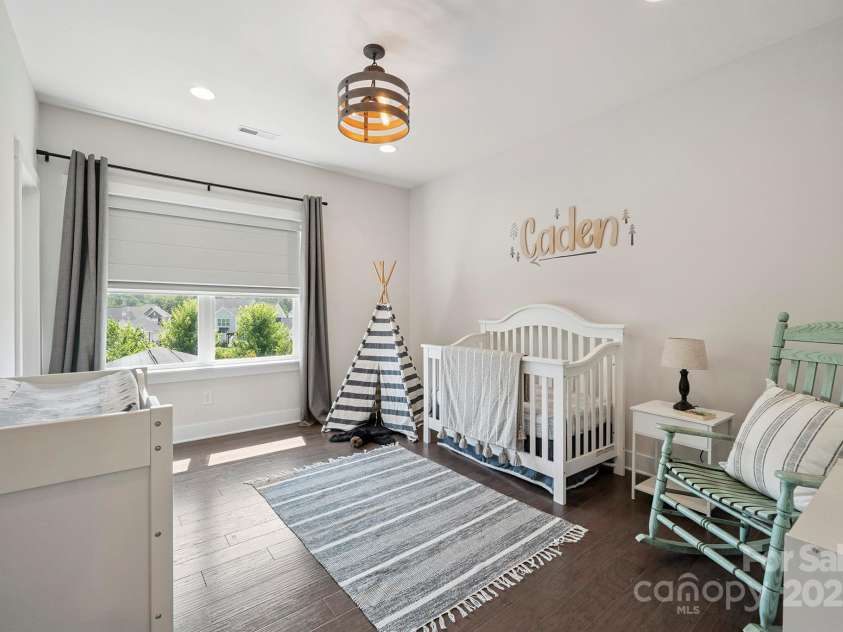 19012 Beecher Commons Drive, Huntersville, NC 28078.  MLS# CAR4276383, YatesRealty ID 32273. Spacious secondary bedroom on upper level with custom light fixture & great natural light!