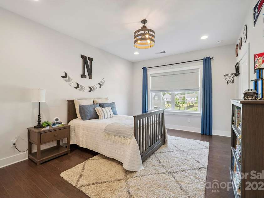 19012 Beecher Commons Drive, Huntersville, NC 28078.  MLS# CAR4276383, YatesRealty ID 32273. Spacious secondary bedroom on upper level with custom light fixture & nice natural light!