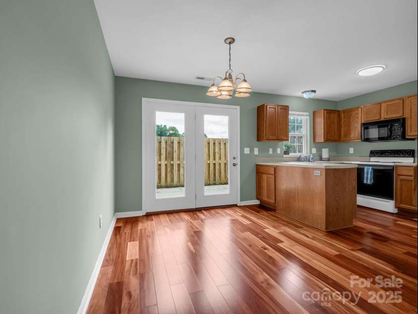 69 Wiltshire Circle, Fletcher, NC 28732.  MLS# CAR4290881, YatesRealty ID 32281. Dining area is located between the kitchen and the living room.