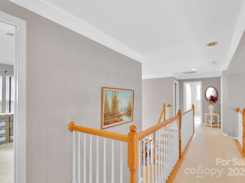 10837 Wilklee Drive, Charlotte, NC 28277.  MLS# CAR4291403, YatesRealty ID 32289. Upstairs hallway/catwalk opens down to foyer with dual staircase on one side and family room on the other side