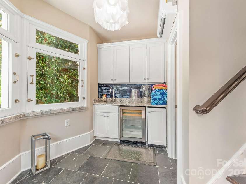 4231 Fox Brook Lane, Charlotte, NC 28211.  MLS# CAR4186375, YatesRealty ID 3229. Windows open to reveal granite ledges creating a cute bar at the pool side, with full bar set up and pool bath.