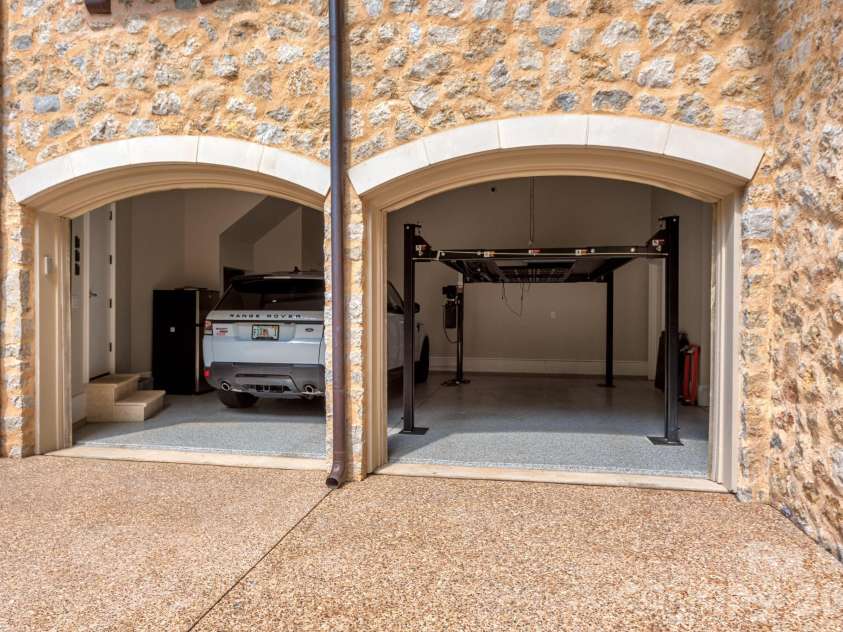 4231 Fox Brook Lane, Charlotte, NC 28211.  MLS# CAR4335388, YatesRealty ID 3229. Two of the three garage bays include hydraulic car lifts.  Room for 5 vehicles inside and several more outside.