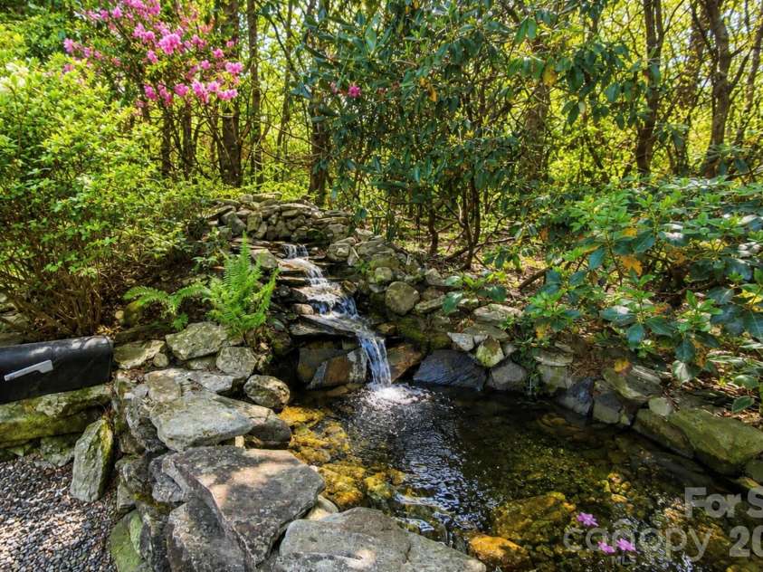 2698 Connestee Trail, Brevard, NC 28712.  MLS# CAR4371714, YatesRealty ID 32300. Private miniature waterfall