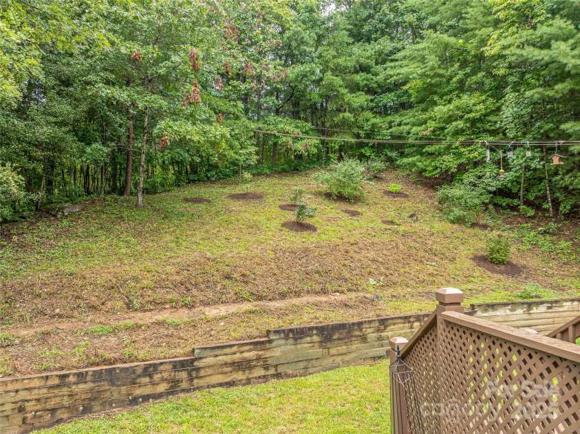 808 Old Fort Road, Fairview, NC 28730.  MLS# CAR4281084, YatesRealty ID 32308. The back deck steps down to a flat back yard. Cornhole, anyone? Terraced area above the flat yard.