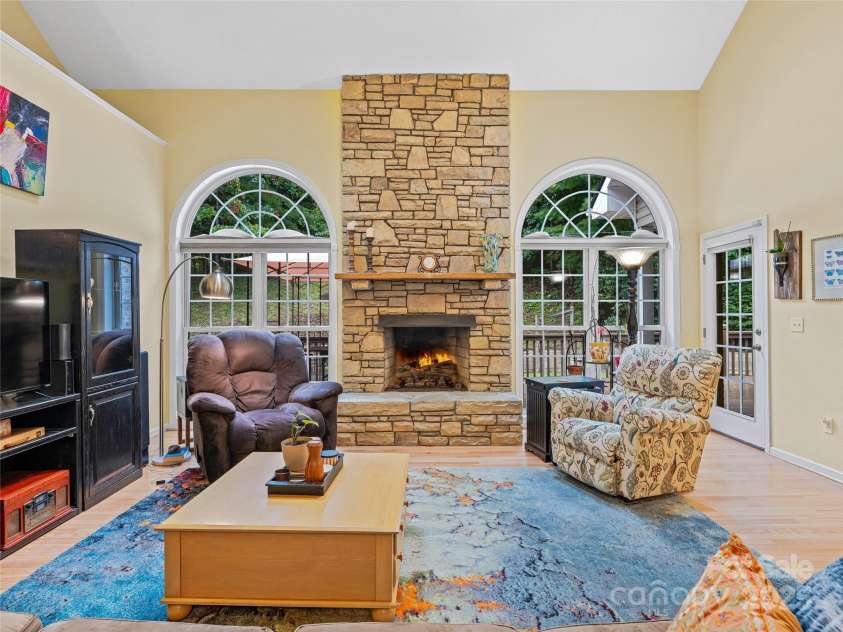 808 Old Fort Road, Fairview, NC 28730.  MLS# CAR4281084, YatesRealty ID 32308. The great room in this home features vaulted ceilings and yet feels cozy with this stone gas log fireplace.