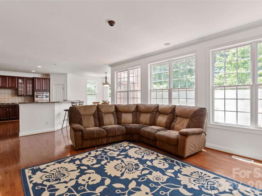 8914 Landsdowne Avenue, Harrisburg, NC 28075.  MLS# CAR4259422, YatesRealty ID 3231. Family room with kitchen showing in the back drop.