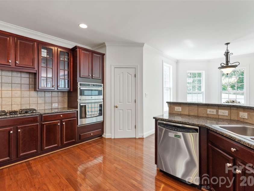 8914 Landsdowne Avenue, Harrisburg, NC 28075.  MLS# CAR4259422, YatesRealty ID 3231. Nice view of kitchen with pantry, cooktop and oven.