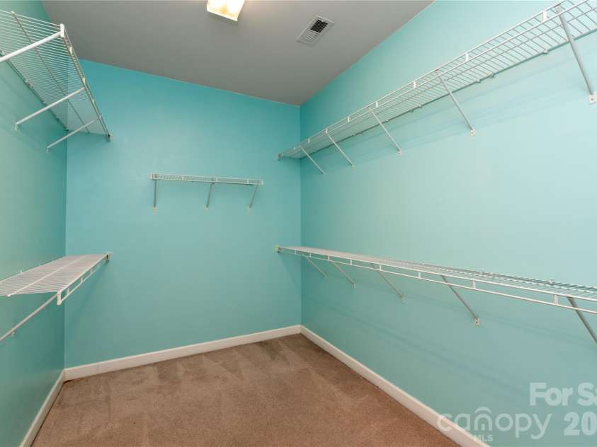 8914 Landsdowne Avenue, Harrisburg, NC 28075.  MLS# CAR4259422, YatesRealty ID 3231. Primary walk in closet with ample space for all your wardrobe.