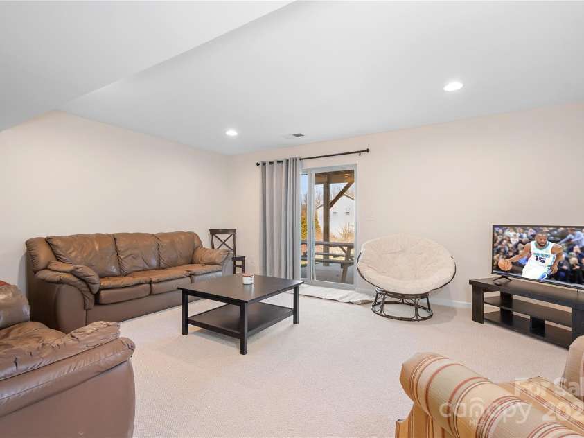 7217 Kenyon Drive, Denver, NC 28037.  MLS# CAR4316332, YatesRealty ID 3235. Basement rec room with sliding glass doors to patio