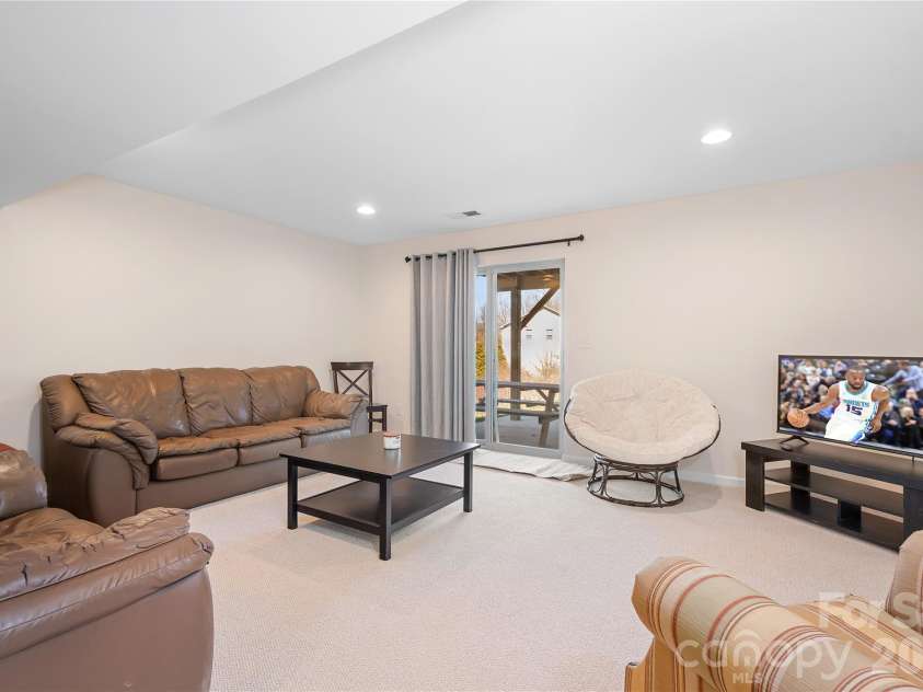 7217 Kenyon Drive, Denver, NC 28037.  MLS# CAR4316332, YatesRealty ID 3235. Basement rec room with sliding glass doors to patio
