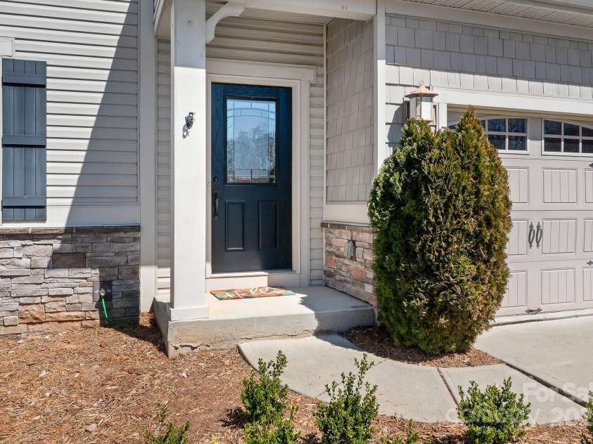 7217 Kenyon Drive, Denver, NC 28037.  MLS# CAR4316332, YatesRealty ID 3235. Front porch and two car garage 