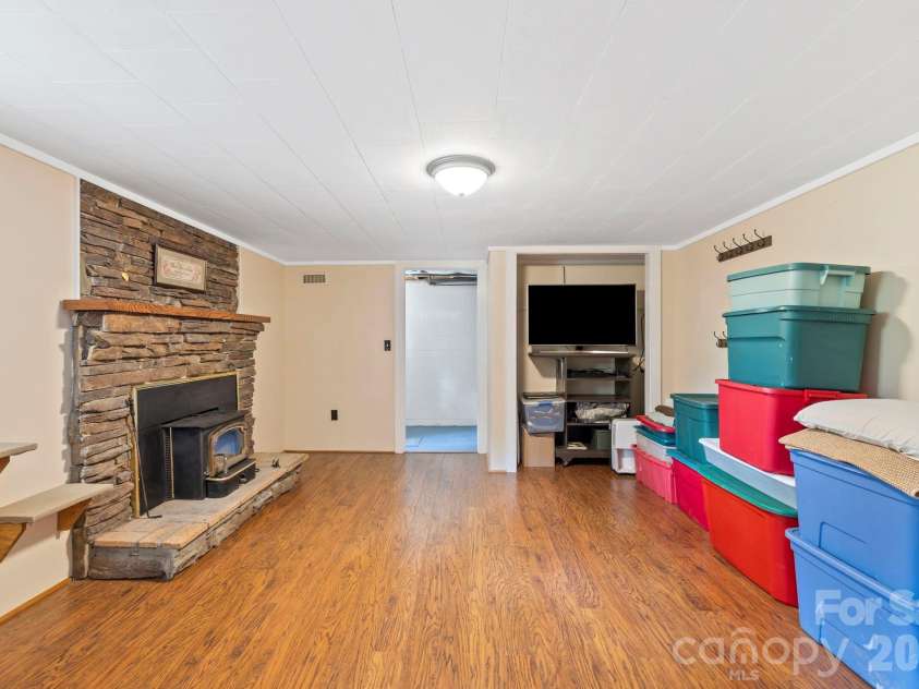 71 Laurel Mountain Road, Brevard, NC 28712.  MLS# CAR4370295, YatesRealty ID 32354. Area downstairs with fireplace
