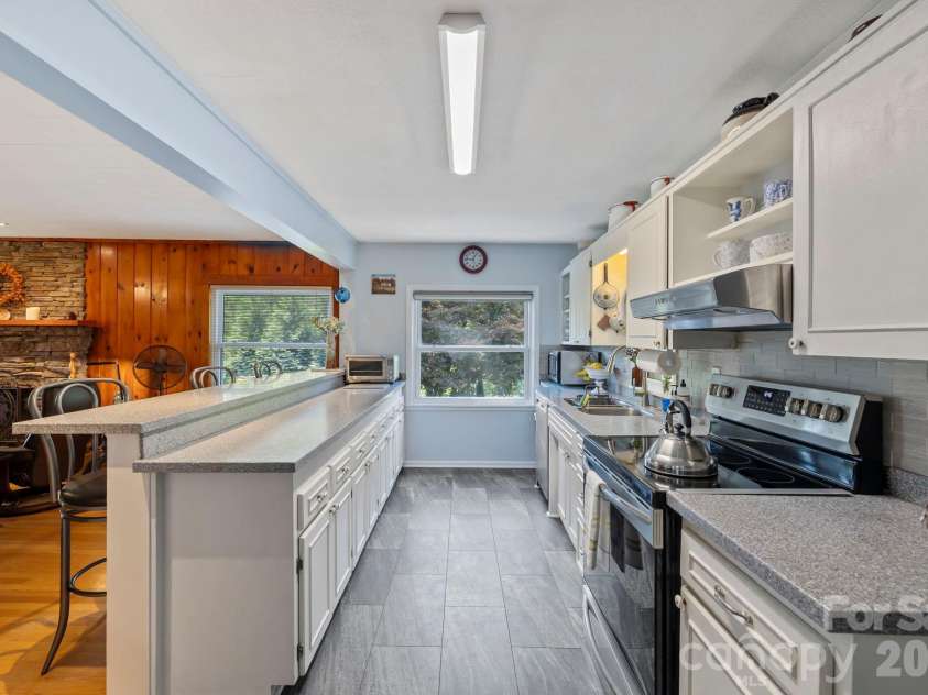 71 Laurel Mountain Road, Brevard, NC 28712.  MLS# CAR4370295, YatesRealty ID 32354. Open kitchen looking into the living room