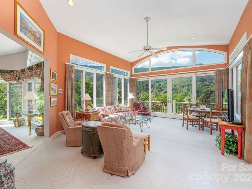 31 Chickering Lane, Waynesville, NC 28786.  MLS# CAR4278199, YatesRealty ID 32361. Sunroom with walls of glass